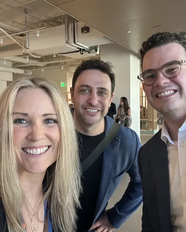 Three team members taking a selfie at an event