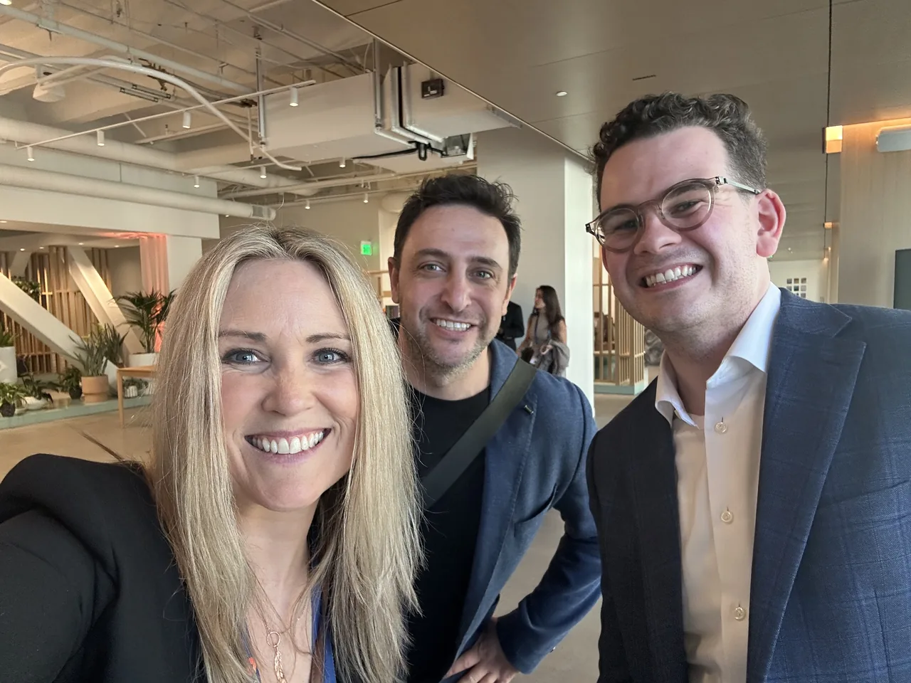 Three team members taking a selfie at an event